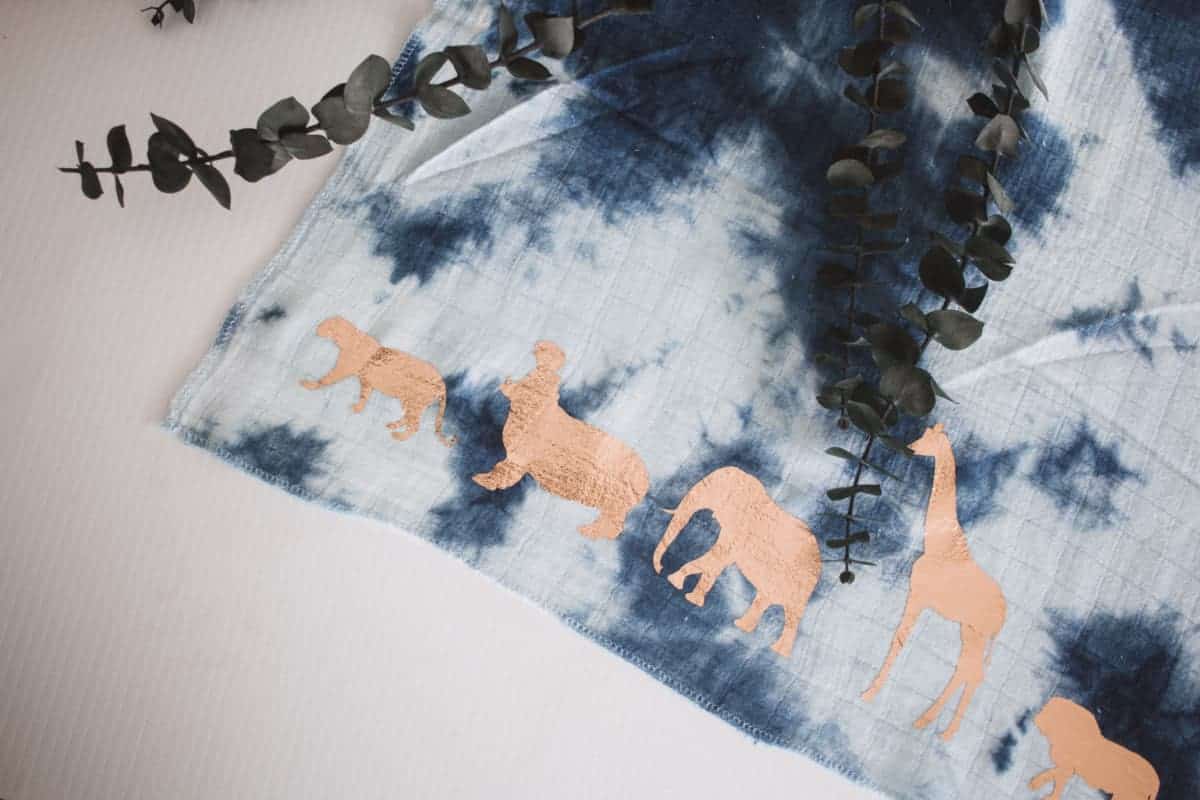 This DIY muslin swaddle blanket has a super fun safari theme making it perfect for any safari themed baby shower or any animal loving mama. 