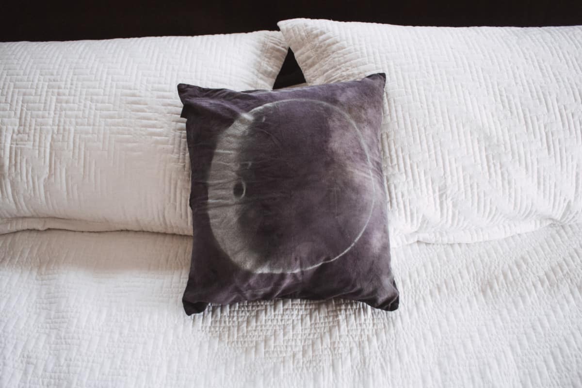 This DIY moon pillow is simple and only requires a can of spray paint to get a really cool look for any room in your home.