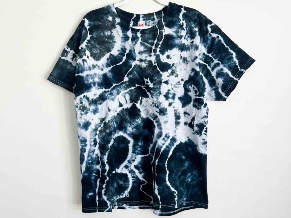 Front view of a black and white geode tie dye t-shirt created with Raven Black dye