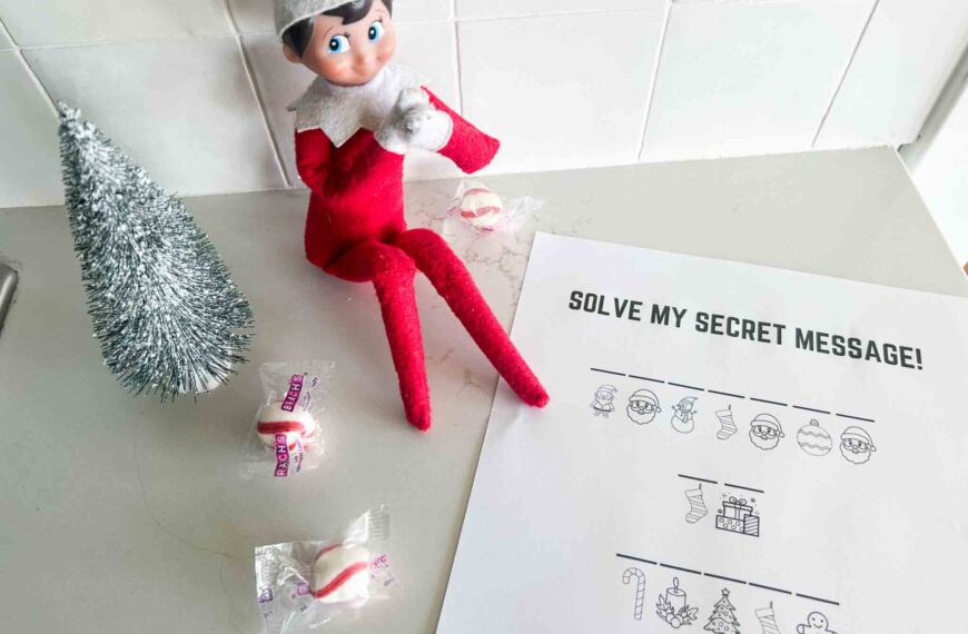 Elf on the Shelf sitting with secret message printable Christmas activity and peppermint candies