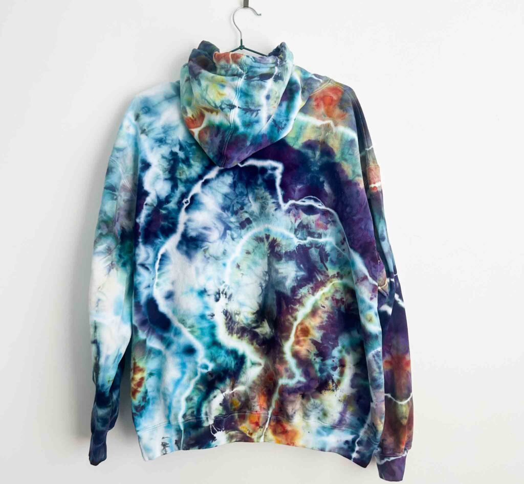 Back view of homemade tie dye hoodie showing organic geode rings with watercolor ice dye effect