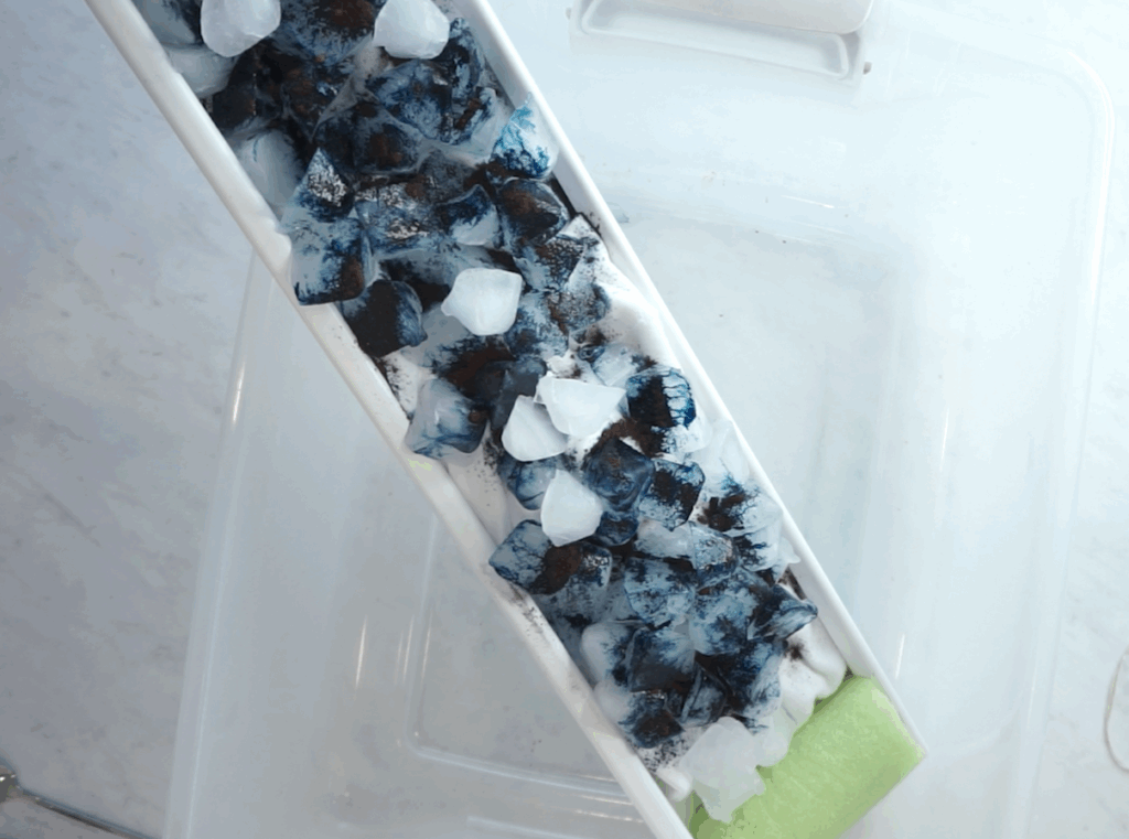 gravity dye ice in a gutter with a pool noodle stopping it