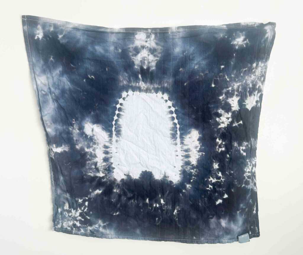 Finished black and white ghost tie dye towel with clear ghost silhouette created using hot water method for Halloween