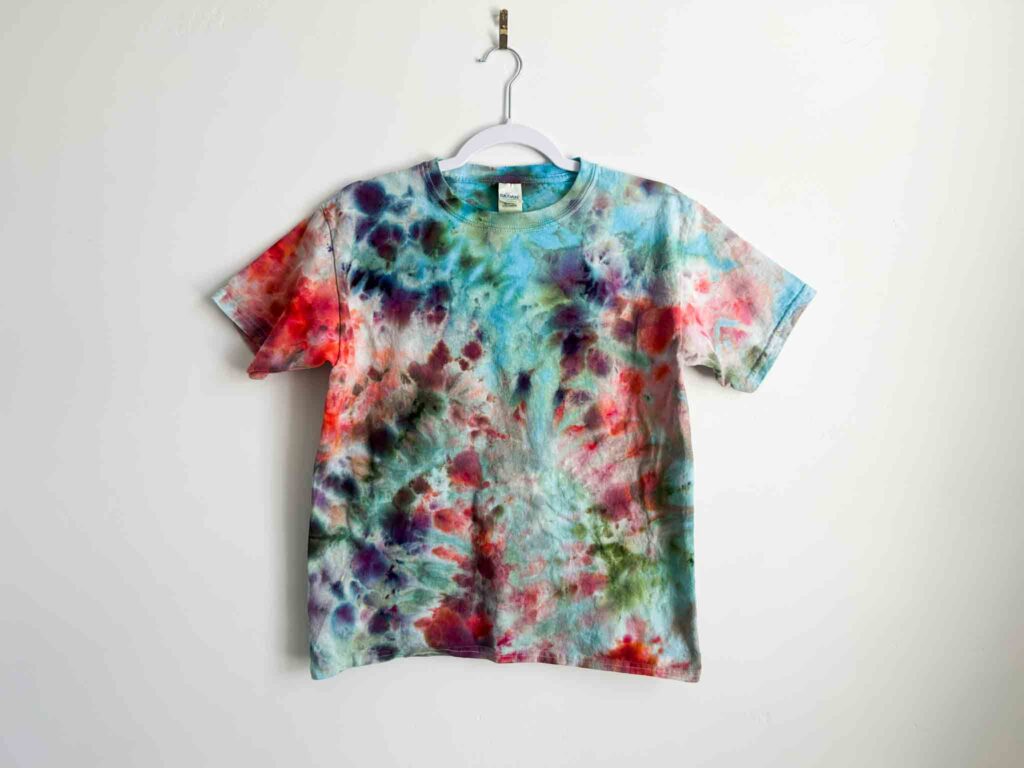 Crumple or scrunch tie dye shirt with soft marbled colors in blue, red, and green.