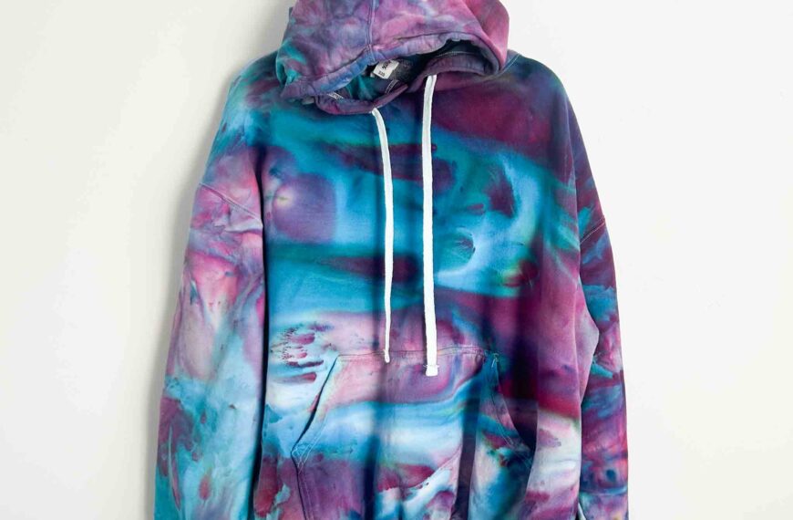 Front view of a gravity tie dye hoodie showing Mind Bender dye with purple and turquoise color splits