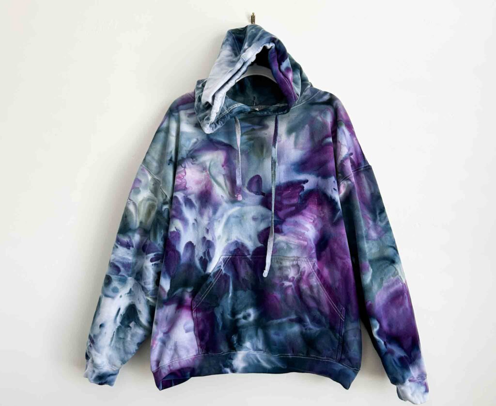 Front view of a purple and gray tie dye hoodie created with a tall deep scrunch technique