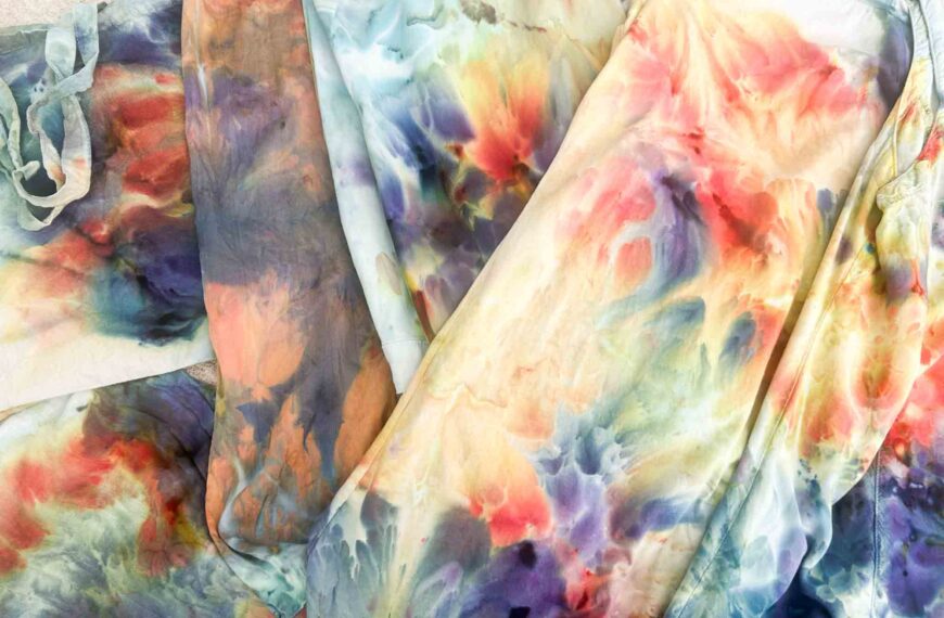 Side-by-side comparison of tie-dyed rayon, cotton jersey, denim, silk, canvas, and bamboo gauze showing how the same Phoenix Flame and Avalon colors behave on different fabrics.