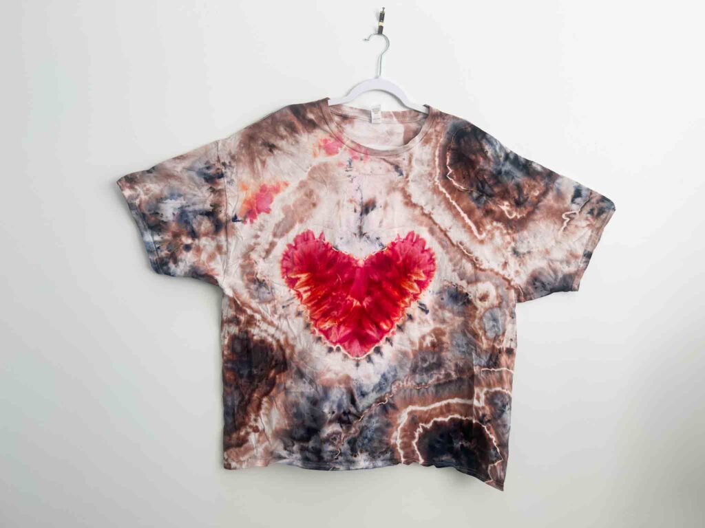 Geode style heart tie dye shirt with textured red heart and earthy ice dye pattern