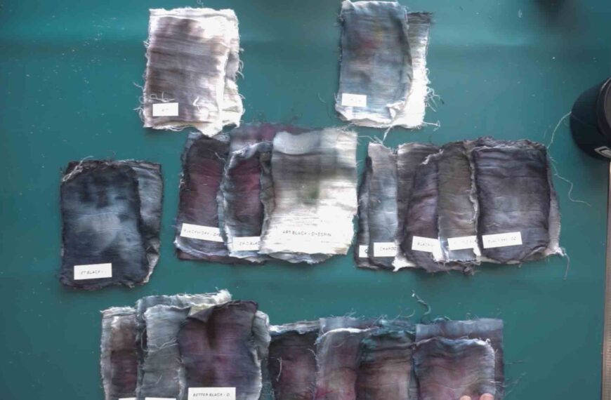 Multiple labeled black ice dye swatches spread across a teal surface showing the full range of results from all brands tested including Jacquard, DyeSpin, Dharma, and Grateful Dyes