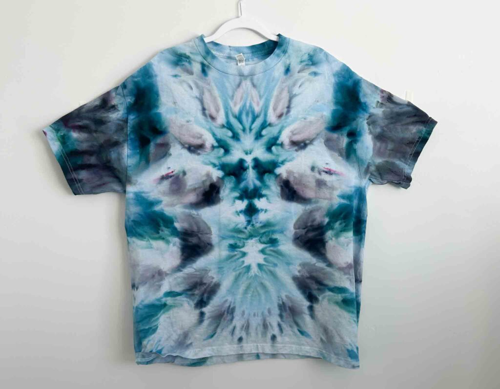 American Apparel white t-shirt tie dyed in a Kingfisher Blue deity roll, showing high-contrast white space