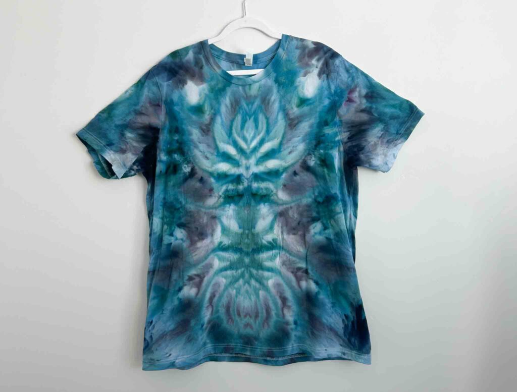 Bella and Canvas Unisex Jersey white t-shirt tie dyed in a blue and teal deity roll pattern