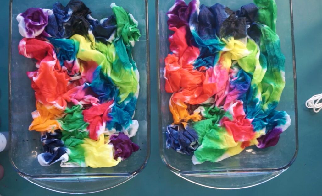 All 18 colors from the Create Basics tie dye party tub swatched on two white tea towels
