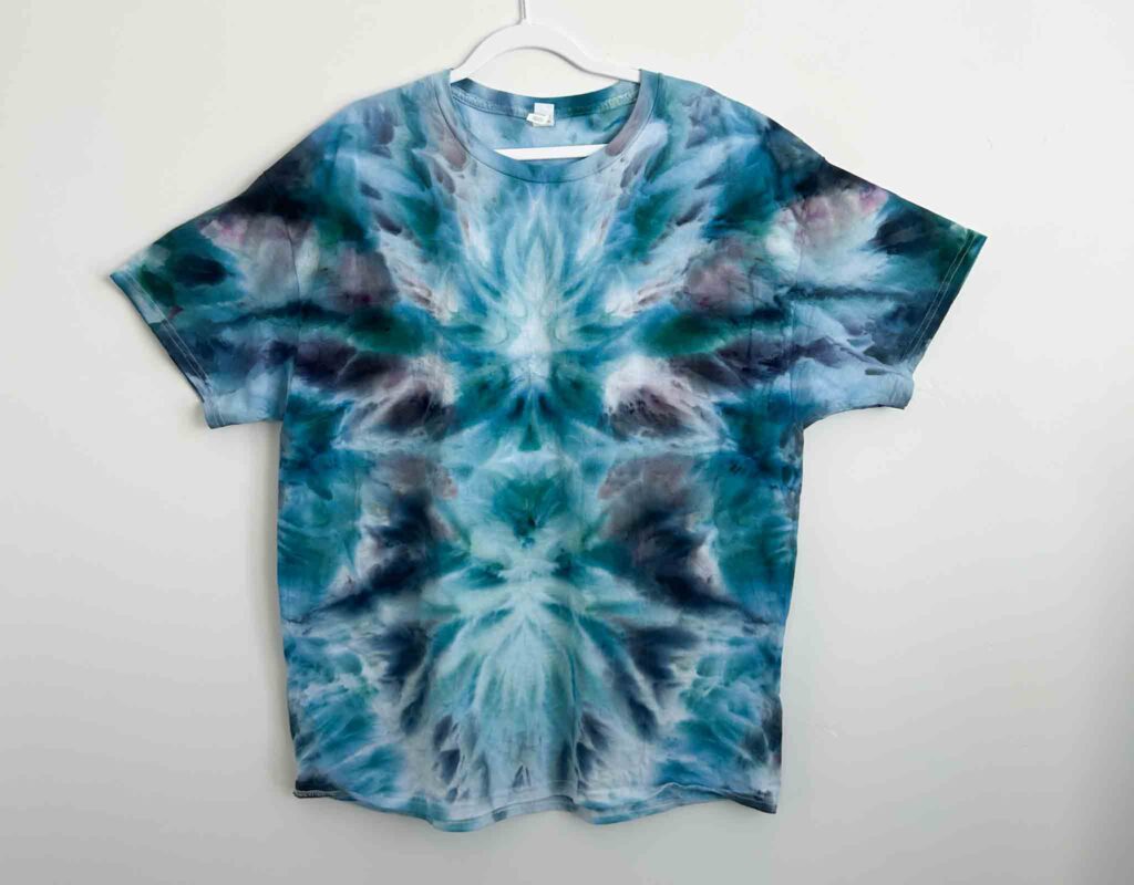 Hanes Authentic white t-shirt tie dyed in a deity roll fold with blue and teal dye