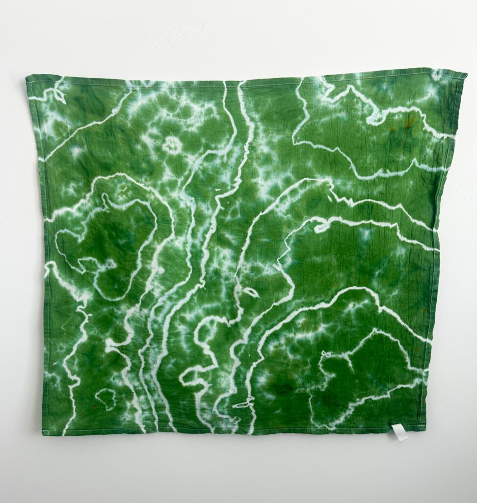 Forest Green geode liquid tie dye on a cotton towel, one leafy green color with crisp white lines