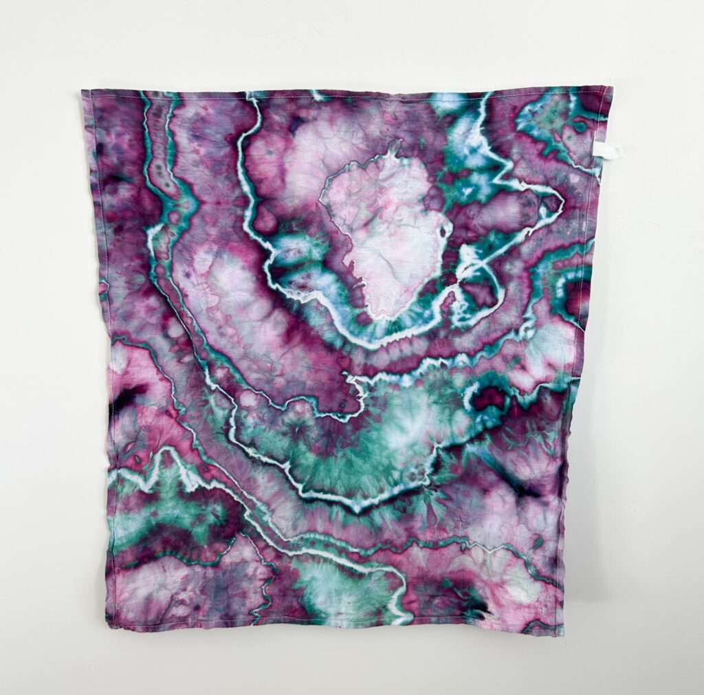 Northern Lights Dharma ice dye swatch with purple and teal color split on a geode tie
