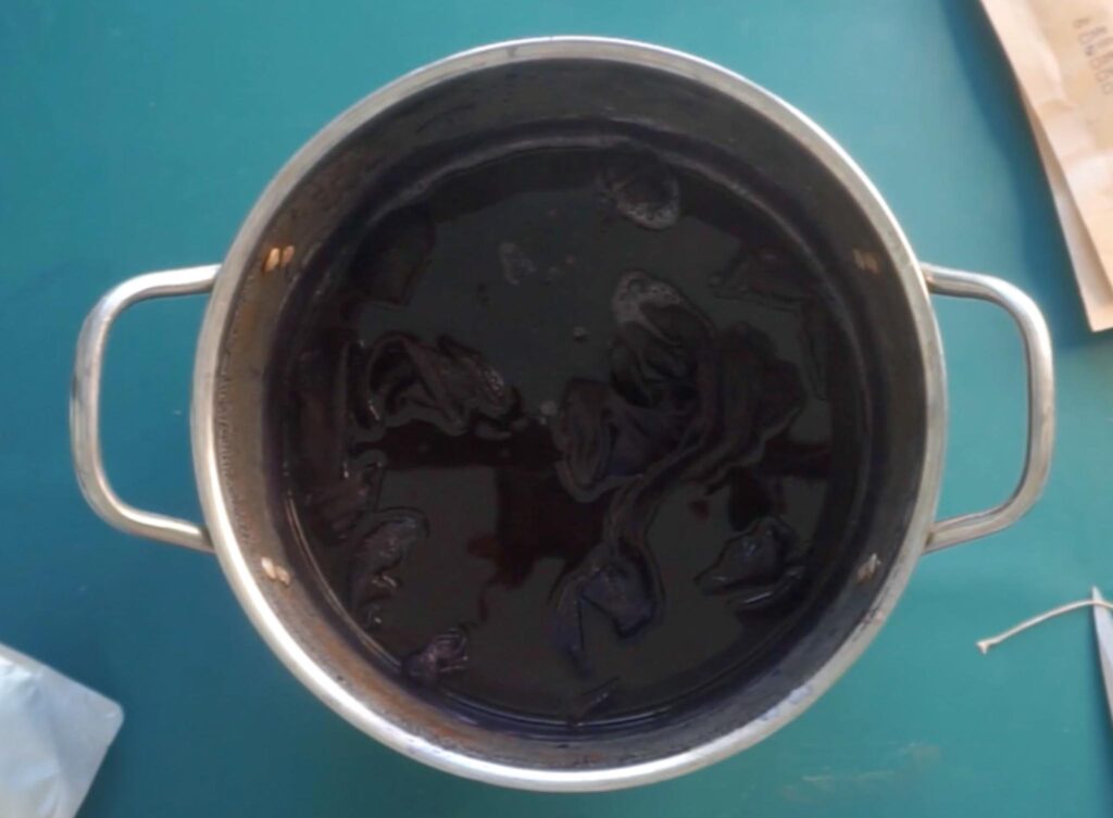 Fabric soaking in a deep logwood dye bath with iron modifier added