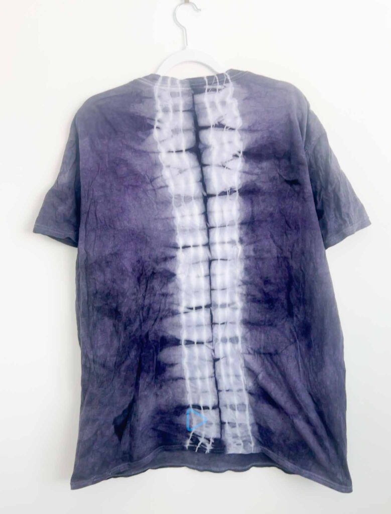 Back view of a logwood dyed shirt showing a spine pattern down the center
