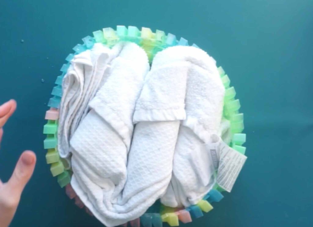 Two folded beach towels secured with rainbow fold clips, ready for tie dye
