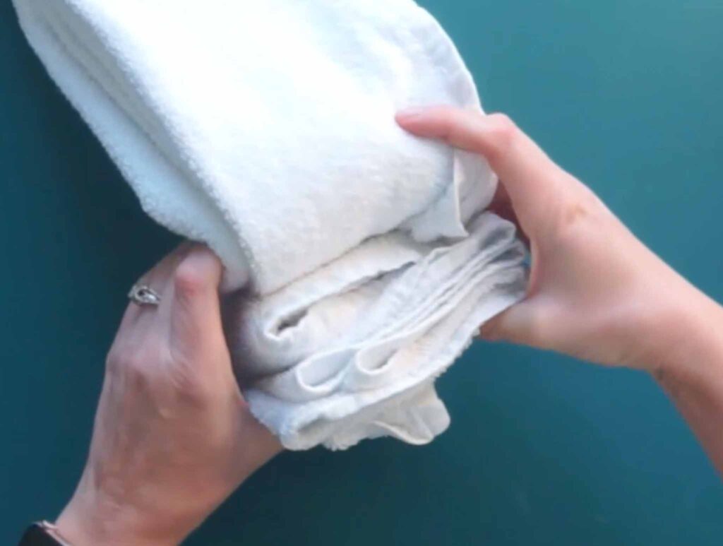 Close-up of the accordion folded beach towel showing the waffle knit and terry cloth sides