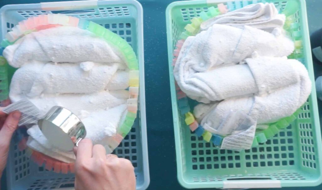 Two soda ash sprinkled beach towels in mesh baskets before dye is applied