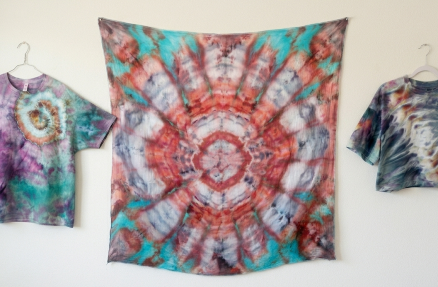 Three unique tie dye patterns side by side: a nautilus spiral shirt in teal and purple, a kaleidoscope pattern in coral and teal, and a psychedelic roll crop top in muted tones