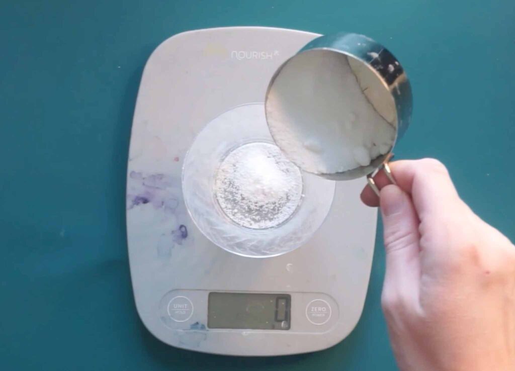Weighing alum on a kitchen scale to mordant fabric before madder root dyeing