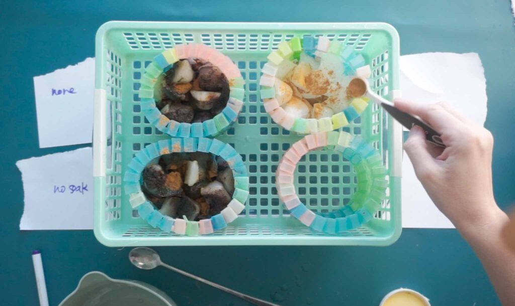 Overhead view of tie dye soda ash soak experiment setup with labeled fabric samples