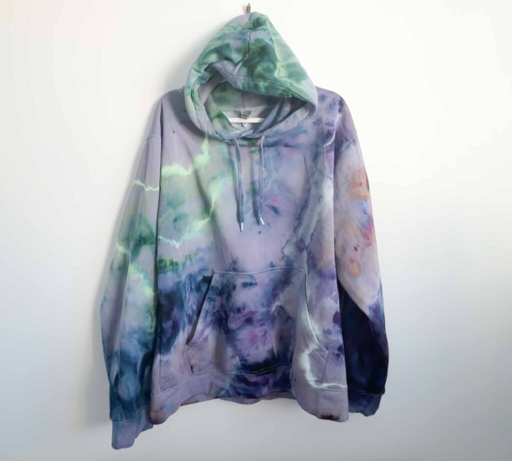 Blank Nights hoodie with a green and purple geode tie dye pattern