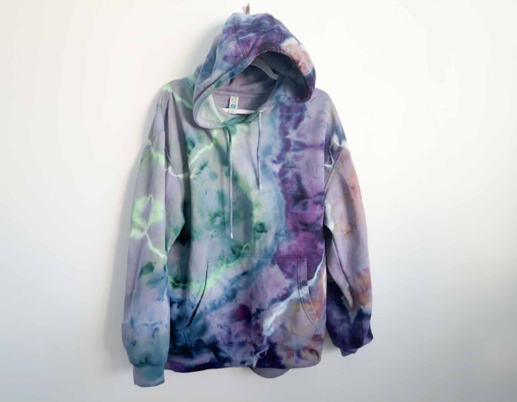 Purple and green geode tie dye on a Lane Seven blank hoodie