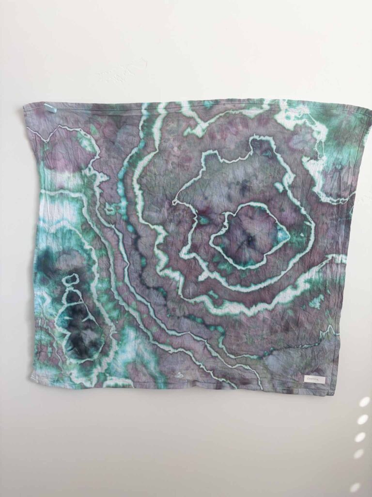 Geode tie dye towel in Dharma x Dalula Aurora, a dusty purple ice dye splitting into bright teal