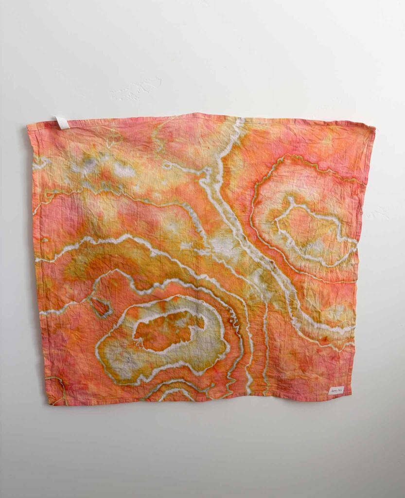 Geode tie dye towel in Dharma x Dalula Honeybee with coral, orange, and golden yellow ice dye splits along white sinew lines
