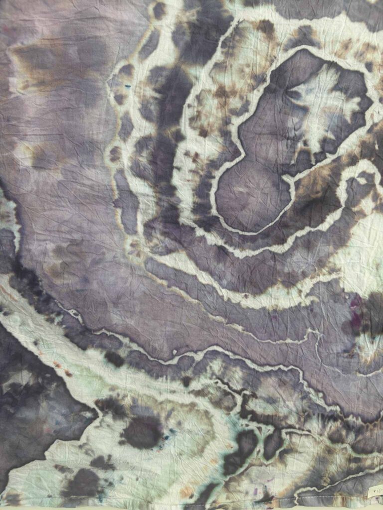 Close-up of Riptide ice dye showing dusty lavender with brown speckles and hints of seafoam