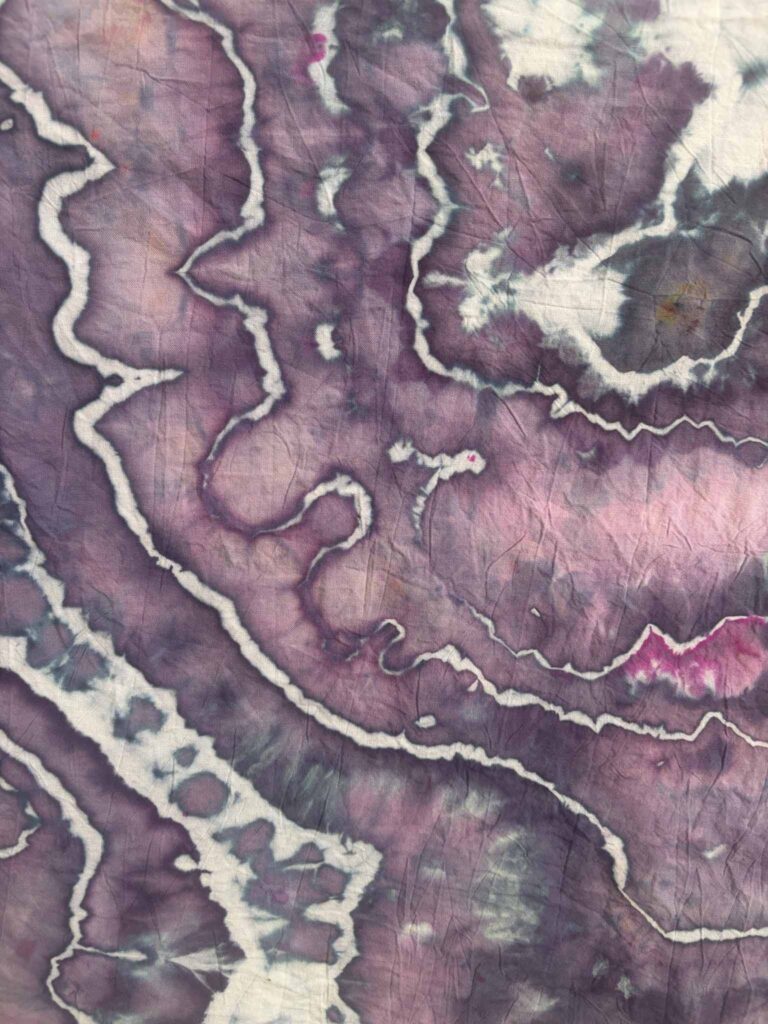 Close-up of Shazam ice dye with bright purple, deep violet edges, and a small pop of magenta