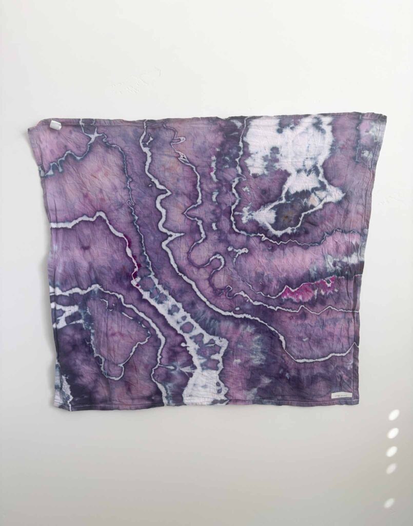 Geode tie dye towel in Dharma x Dalula Shazam, a mostly purple ice dye with darker purple along the sinew lines