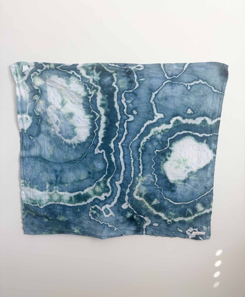 Geode tie dye towel in Dharma x Dalula Undertow, a slate teal ice dye splitting into seafoam green