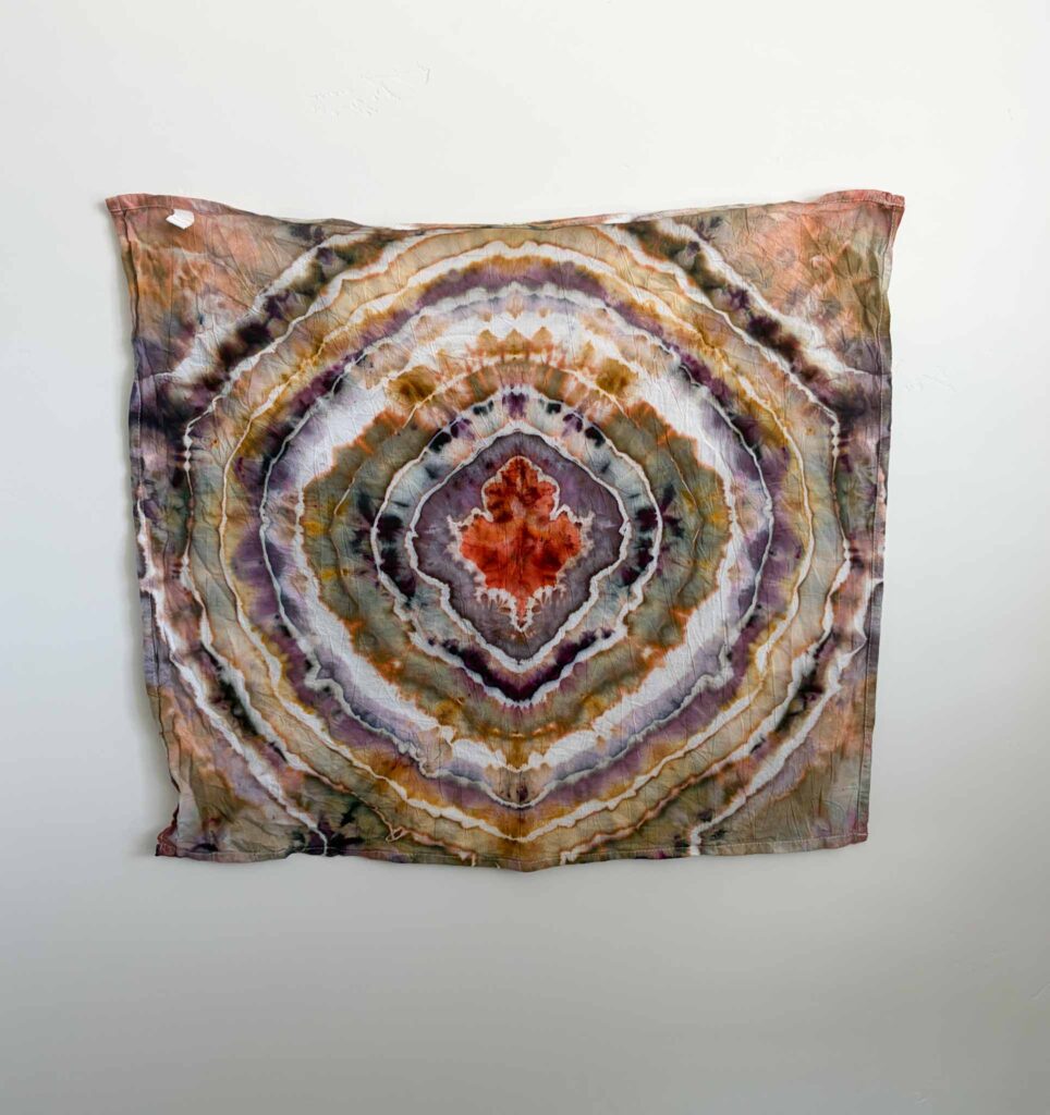 Fall tie dye maple leaf fold with a pagoda red center surrounded by amber waves and black cherry rings