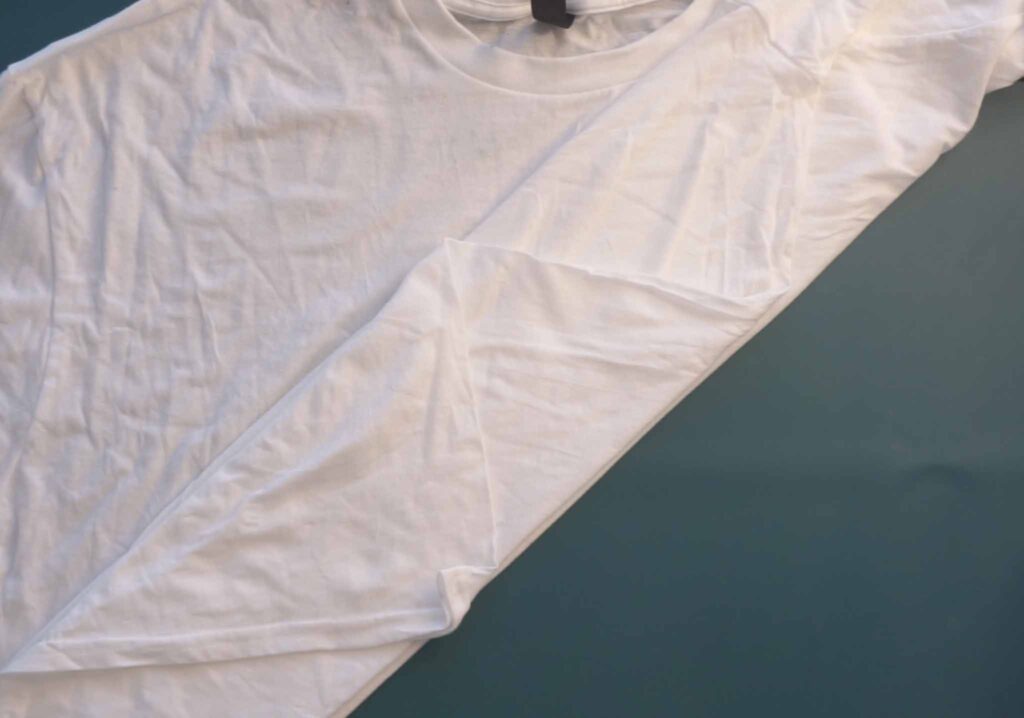Diagonal accordion fold on a white t-shirt for the fern fold tie dye pattern