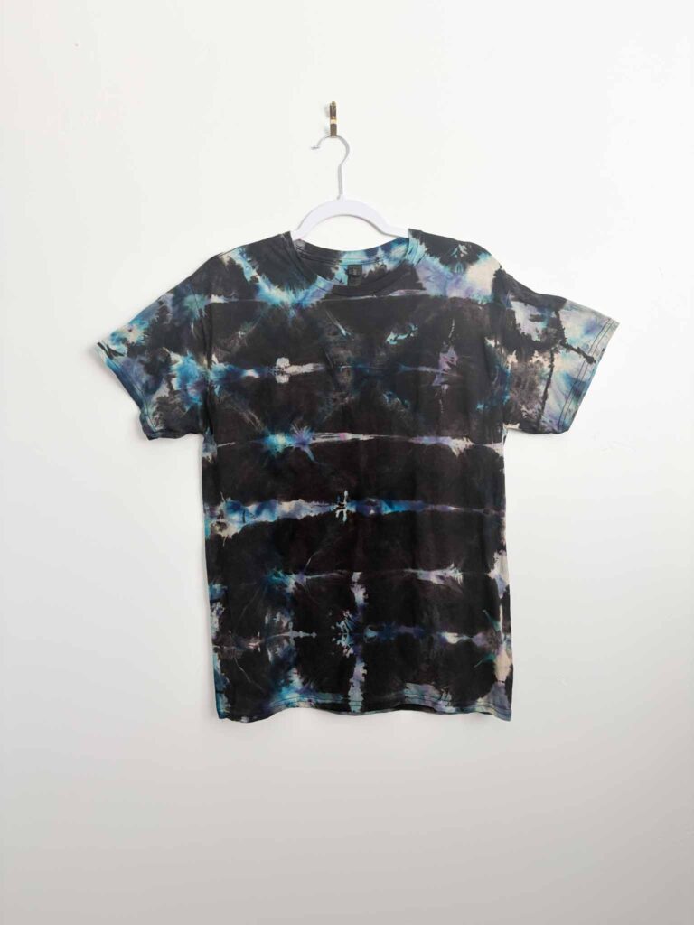 Reverse tie dye shirt with a shibori pattern in blue and black