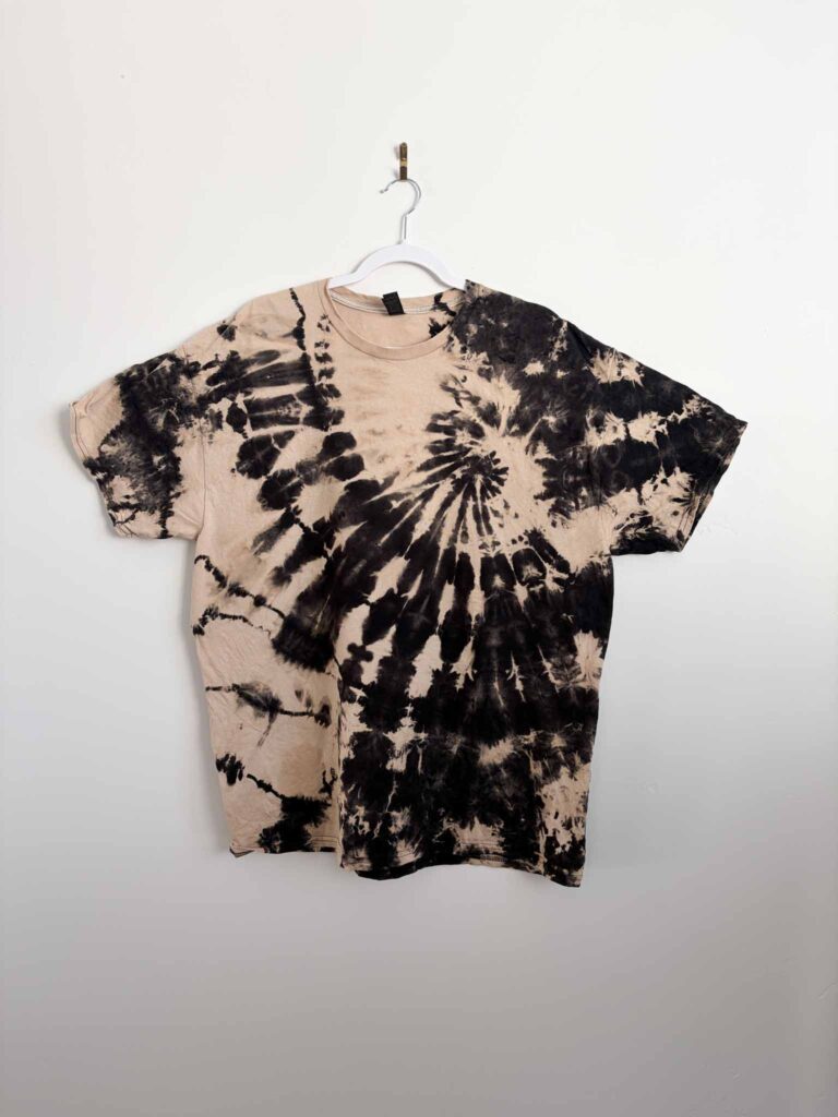 Black shirt with a spiral reverse tie dye pattern made using Out White Brite