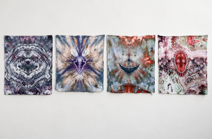 four halloween tie dye shapes on a wall